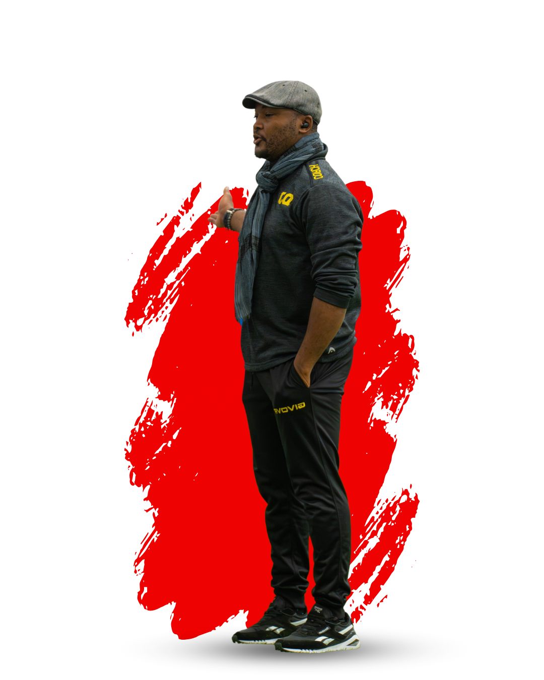 soccer coach standing with arm extended giving soccer instructions on a red background